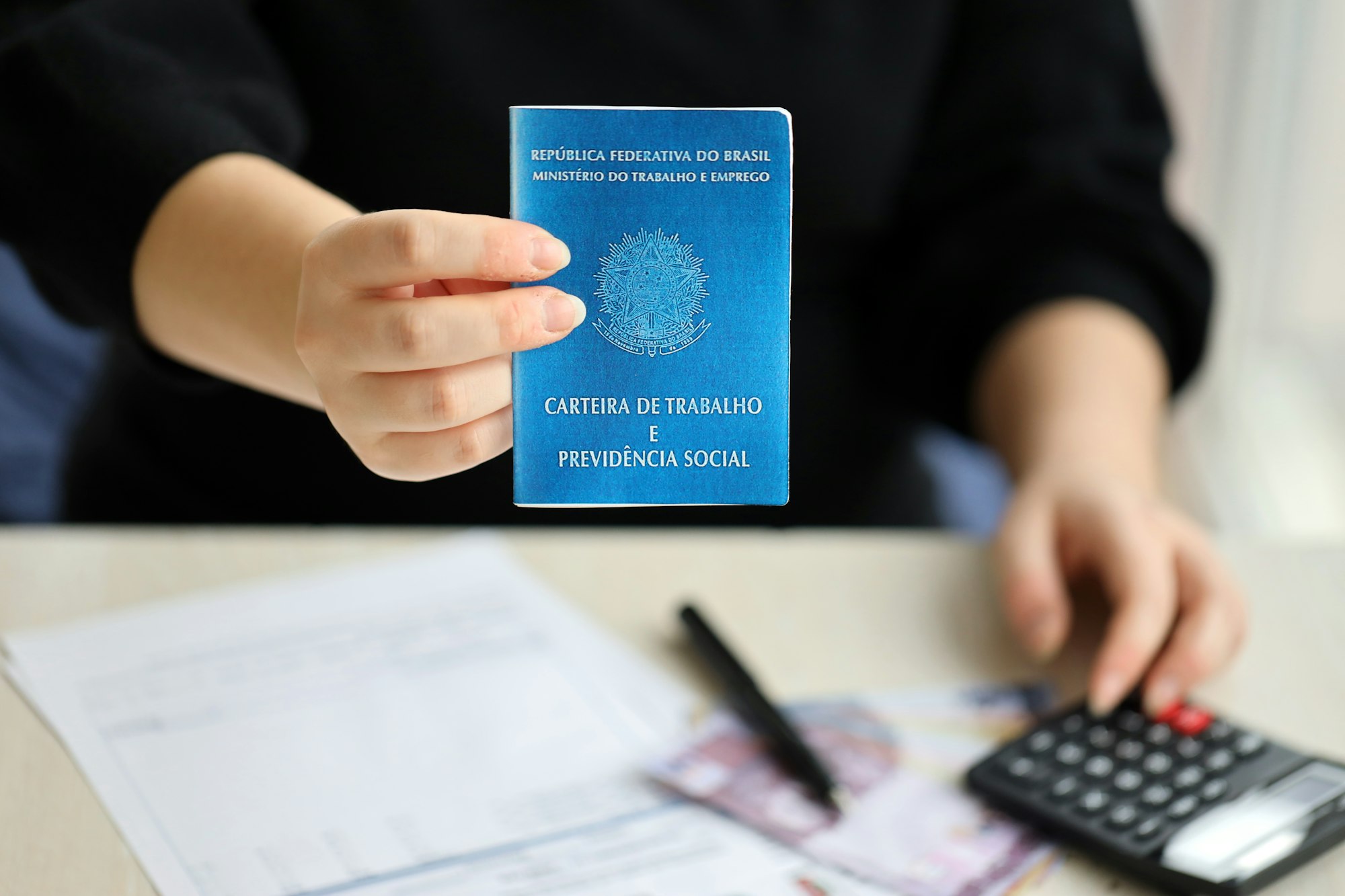 Woman boss gives a brazilian work card and social security blue book to us in employment office